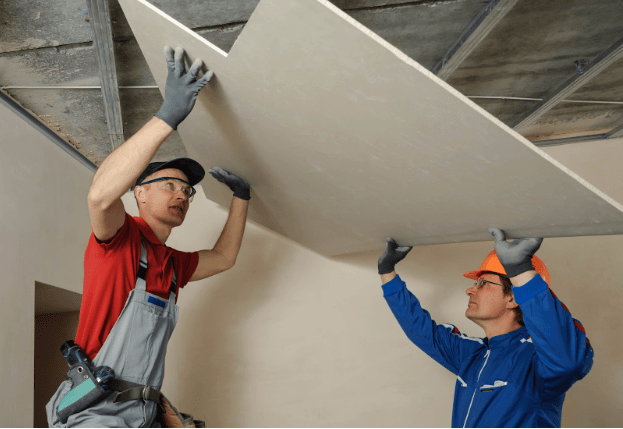 men working on installing a drywall ceiling